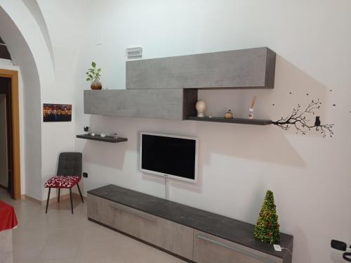 a living room with a tv on a wall at Chez-vous in Molfetta