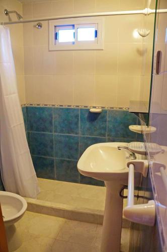 a bathroom with a sink and a shower at Altos del Plata in Villa Carlos Paz