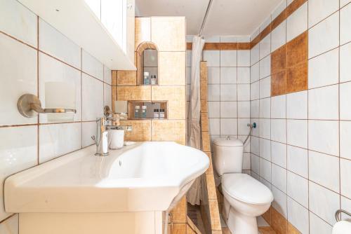 a bathroom with a sink and a toilet at Boutique Apartment with ParkView in Heraklio Town