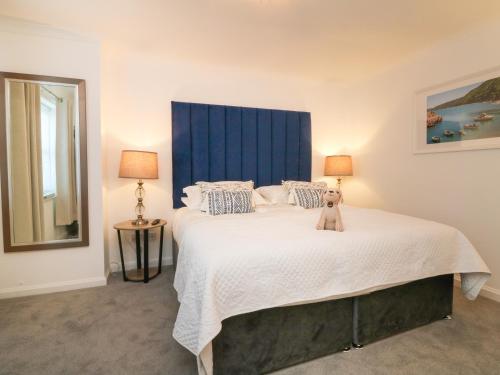 a bedroom with a large bed with a teddy bear on it at 4 Woodland Park in Bideford