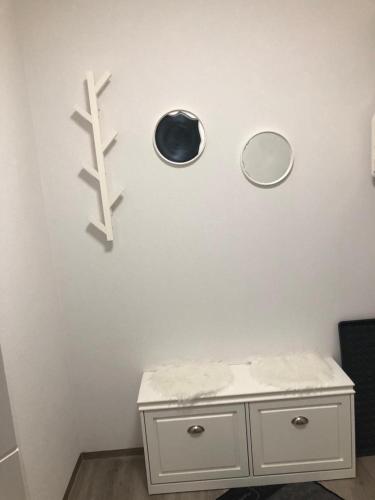 a bathroom with two mirrors and a white cabinet at Sonthof City in Sonthofen