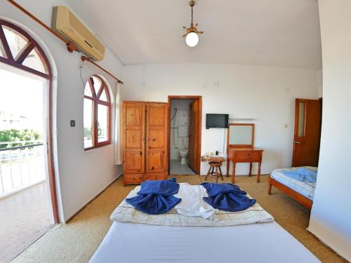 a bedroom with a bed with blue sheets on it at Murat Hotel in Demre
