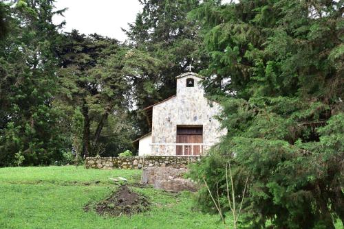 an old stone church in a field with trees at Condominio Hacienda Shangrila in San Francisco