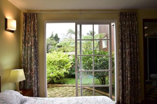 a bedroom with a door open to a garden at Condominio Hacienda Shangrila in San Francisco