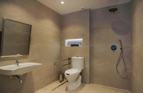 a bathroom with a toilet and a sink and a shower at Celine Luxury Apartments & Suites in Agios Nikolaos