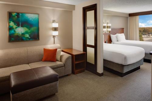 a hotel room with a bed and a couch at Hyatt Place Princeton in Princeton