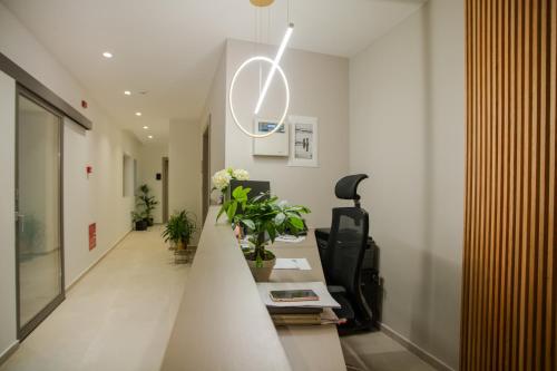 a hallway of an office with a staircase with plants at Celine Luxury Apartments & Suites in Agios Nikolaos