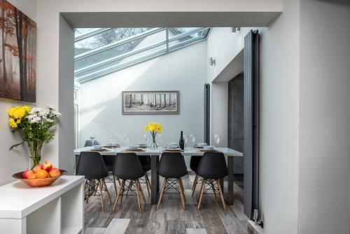 a dining room with a table and chairs at Pen-y-Coed ⥈ Modern ⥈ Hot Tub ⥈ Beautiful Views in Abergele