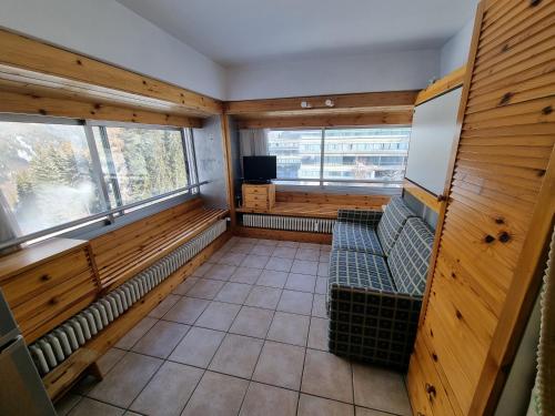 a empty room with benches and a tv and a window at Marilleva in Marilleva
