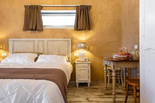 Schlafzimmer mit einem Bett, einem Schreibtisch und einem Fenster in der Unterkunft Aria di Bosco in LʼAquila