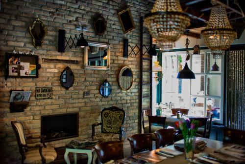 a dining room with a brick wall and a fireplace at Aria di Bosco in LʼAquila