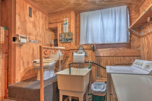 a wooden bathroom with a sink and a toilet at Waterfront Arkdale Retreat 2 Acres with Deck and View in Arkdale
