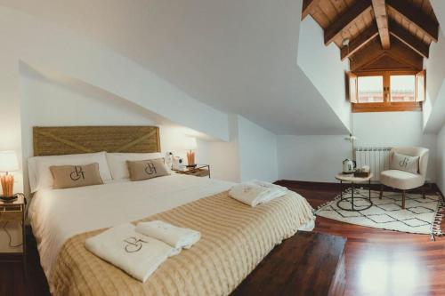 a bedroom with a large bed with two pillows on it at El Piolet de Camprodon in Camprodon