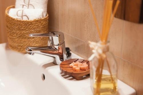 a bathroom sink with a faucet and a bowl of soap at El Piolet de Camprodon in Camprodon