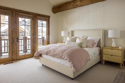 a bedroom with a bed and a large window at Western Tanager Cabin in Big Sky