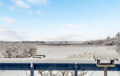 a snow covered balcony with a view of a field at 2 Bedroom Awesome Home In Thyholm in Thyholm