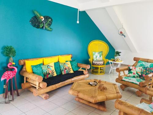 a living room with a couch and a table at Le Caillou Blanc in Saint-Paul