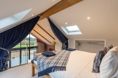 a bedroom with a bed and a large window at Stags Mount in Pickering