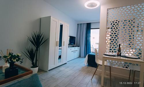 a living room with a table and a dining room at MNG-APART Studio D-14 Mareverde Costa Adeje in Adeje