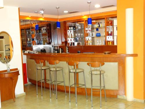 a bar with stools in a room at Faros II in Piraeus