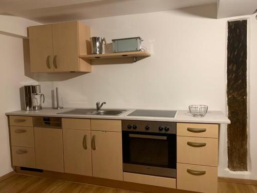 a kitchen with a sink and a stove at Ferienwohnung Lukas in Frielendorf
