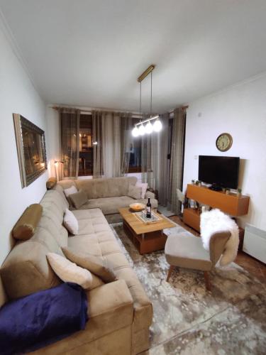 a living room with a couch and a tv at Apartman Royal Vlašić in Vlasic