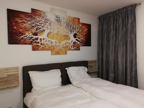 a bedroom with two beds and a painting on the wall at RIVER SIDE near FRANKFURT ----- STAY LIKE AT HOME ----- in Hainburg
