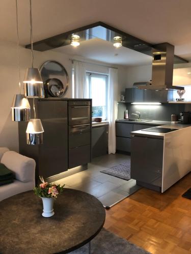 a kitchen with black cabinets and a table in a room at Auszeit in Überlingen