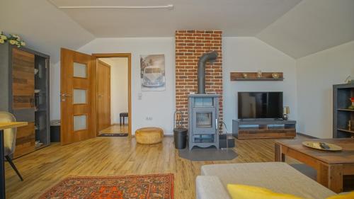 a living room with a fireplace and a stove at Vilux with indoor private parking in Braşov