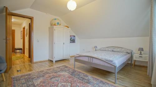 a bedroom with a bed and a cabinet and a rug at Vilux with indoor private parking in Braşov