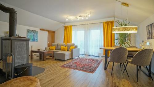 a living room with a table and a dining room at Vilux with indoor private parking in Braşov