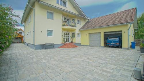 a house with a garage and a driveway at Vilux with indoor private parking in Braşov