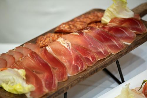 a close up of a piece of meat on a cutting board at Hotel Sumadija in Belgrade