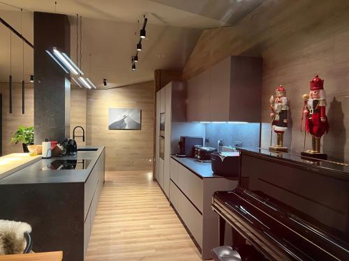 a kitchen with wooden floors and a large kitchen at Luxury Summit Penthouse - Soldeu - By Ski Chalet Andorra in Soldeu