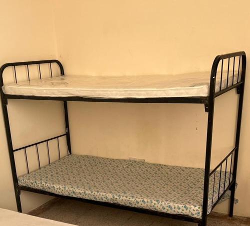 a bunk bed with a shelf in a room at Stay at gomeetingwith in Sharjah