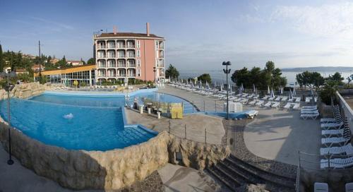 a large swimming pool in front of a building at Hotel Aquapark Žusterna in Koper