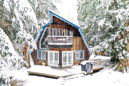 a cabin in the woods in the snow at Alpine Lodge in Glacier