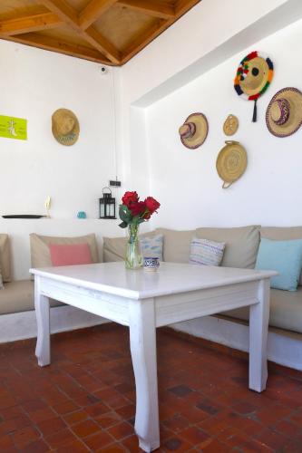 a white table with a vase of flowers on it at Riad Darna in Tetouan