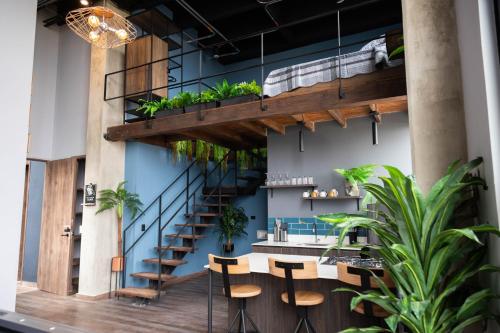 a room with a staircase and tables and chairs at Royal Living Poblado in Medellín