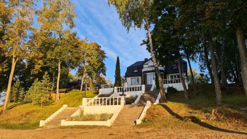 a house on a hill with stairs and trees at Slėnis Trakuose in Trakai