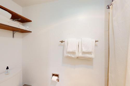 a bathroom with white towels hanging on a wall at Away Out on the Mountain in Crested Butte