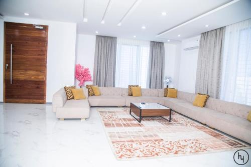 a living room with a couch and a coffee table at Kibada White Villa in Dar es Salaam