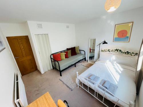 a living room with a bed and a couch at Greenwich Apartments by Sleepy in London