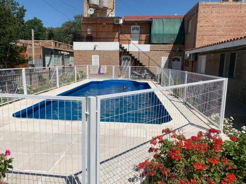a fence around a swimming pool on top of a building at Cabañas San Gabriel Carlos Paz in Villa Carlos Paz
