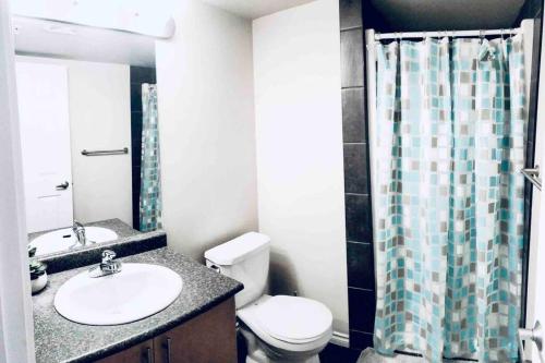 a bathroom with a sink and a toilet and a shower at 2 BDRM A/C Condo w/Ensuite Laundry + Free Parking in Edmonton