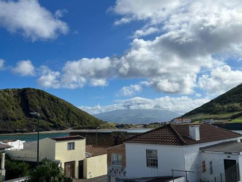 a view of a body of water and mountains at Casa das Palmeiras - Res. of Elizabete and Fatima in Horta