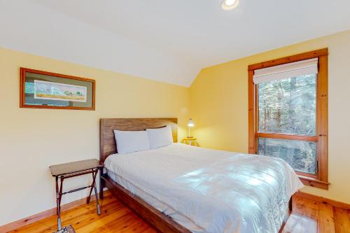 a bedroom with a large bed and a window at Rescue Lake in Ludlow