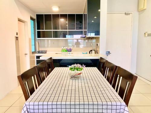a kitchen with a table with flowers on it at Deco Home @ Imago The Loft in Kota Kinabalu