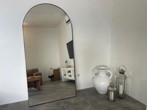 a mirror in a room with a vase and a table at Cabana in Gili Islands