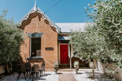 a red brick house with a red door at Riddell Cottage - A Federation Hideaway in Town in Mudgee